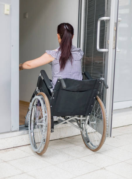 Businesswoman with spinal cord injury in a wheelchair entering office